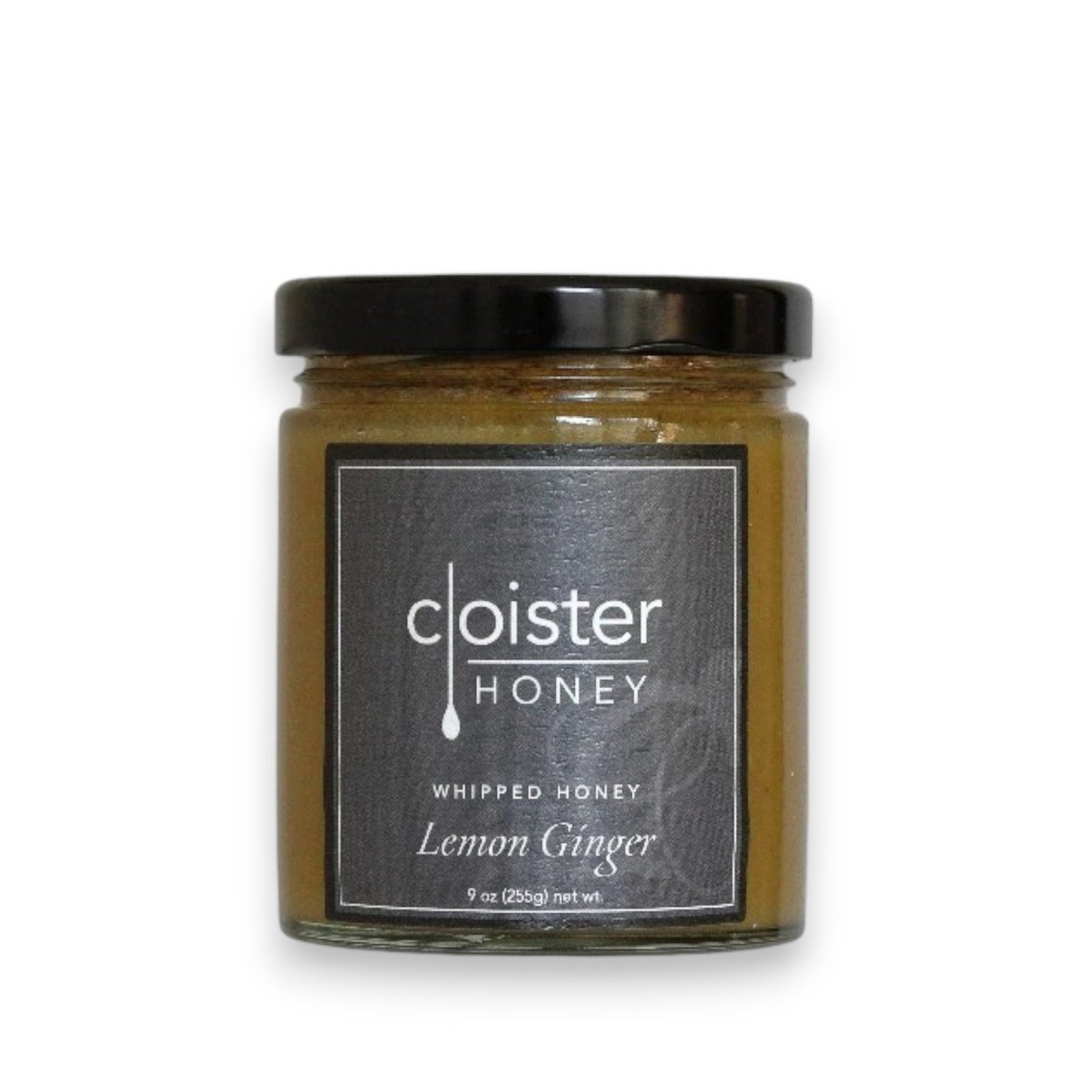 The product is a 9-ounce (255 grams) jar of Cloister Honey - Whipped Lemon Ginger Honey. The jar features a black label with white text and has a matching black lid. Inside, the honey has a smooth, light brown appearance.