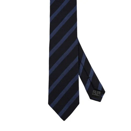 The AMANDA CHRISTENSEN Striped Jacquard Woven Silk Tie in Blue, featuring a black base with diagonal dark blue stripes, is showcased against a white background.