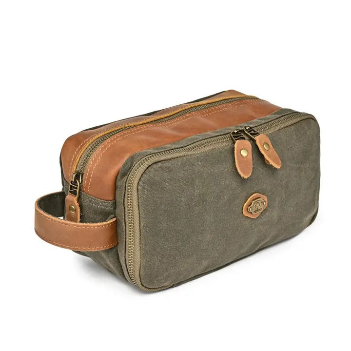 The TSD BRAND Turtle Ridge Toiletry Bag in Olive features leather accents and durable waxed canvas. Grooming essentials fit neatly in elastic loops and mesh pockets, making it the perfect travel companion.