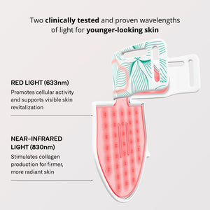 An OMNILUX - CONTOUR NECK & DECOLLETE KIT device by OMNILUX, featuring a white and pink pattern and designed for red light therapy, stands upright on a white surface with soft red light glowing around its edges.