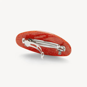 The MACHETE Jumbo Oval Barrette in Poppy features marbled orange Italian acetate with a glossy finish, shown on a plain white background.