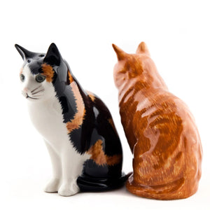 The QUAIL CERAMICS - ELEANOR & VINCENT CAT SALT & PEPPER SHAKERS by QUAIL DESIGNS feature an orange tabby and a black, white, and orange cat—ideal for any cat lover or to add charm to your kitchen decor.