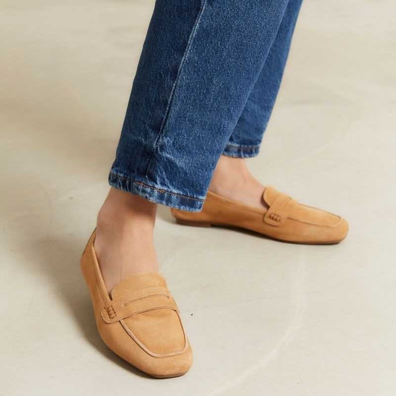 Close-up of REQINS - HEMA SUEDE LOAFER IN CAMEL, featuring a stitched design, decorative strap, leather insole, and soft textured finish for a classic and elegant look.