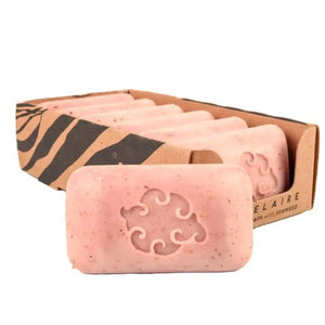 The BAUDELAIRE Grapefruit Loofa Bath Soap (5oz) is a pink rectangular bar featuring exfoliating seaweed, small brown specks, and a decorative swirl pattern embossed in the center. It offers a natural citrus fragrance that invigorates your senses.