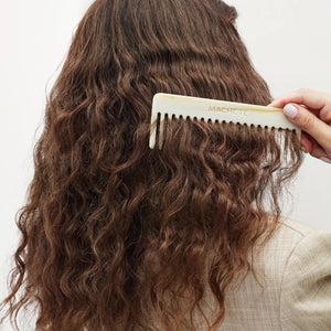 The MACHETE No. 2 Comb in Blonde Tortoise by MACHETE is a handcrafted Italian acetate comb with wide teeth, featuring a blonde tortoiseshell pattern of alternating dark brown and beige spots, shown vertically on a white background.