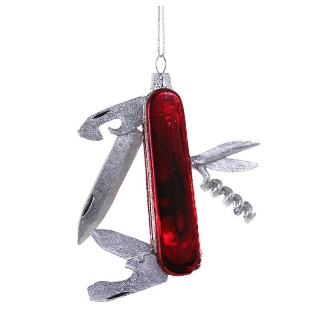 A 3.5-inch GLASS SWISS ARMY KNIFE ORNAMENT by Cody Foster, shaped like a multi-tool pocket knife with a red handle and silver folded blades.