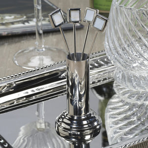 The ZODAX SPIGA COCKTAIL PICKS WITH STAND includes 4 brass alloy picks with square handles in a shiny silver 2x2x5-inch holder, set against a white background.