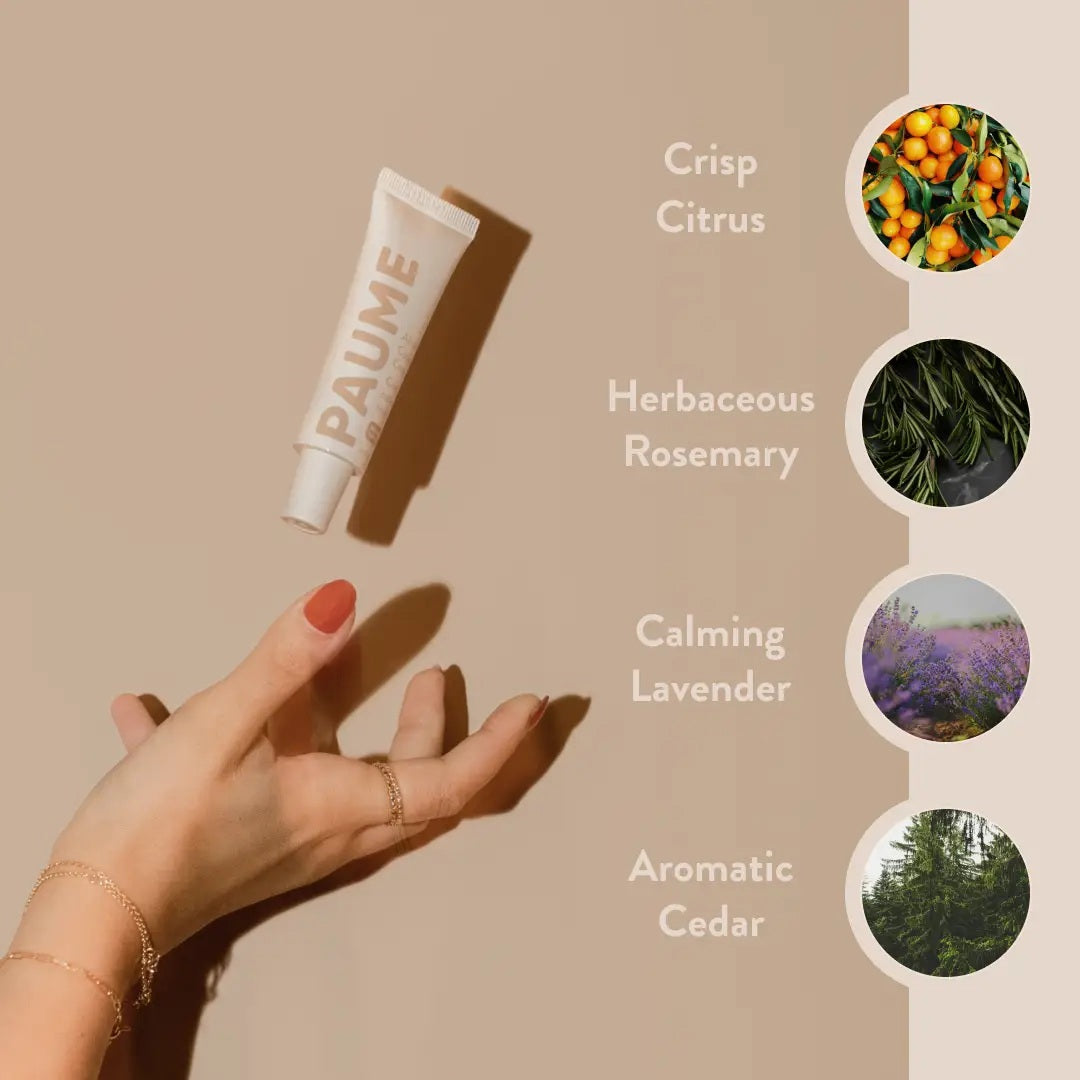 A tube of PAUME - ALL IN ONE CUTICLE AND NAIL CREAM by PAUME, infused with plant-based keratin, stands upright against a light beige background, showcasing minimal modern packaging in soft pink and white.