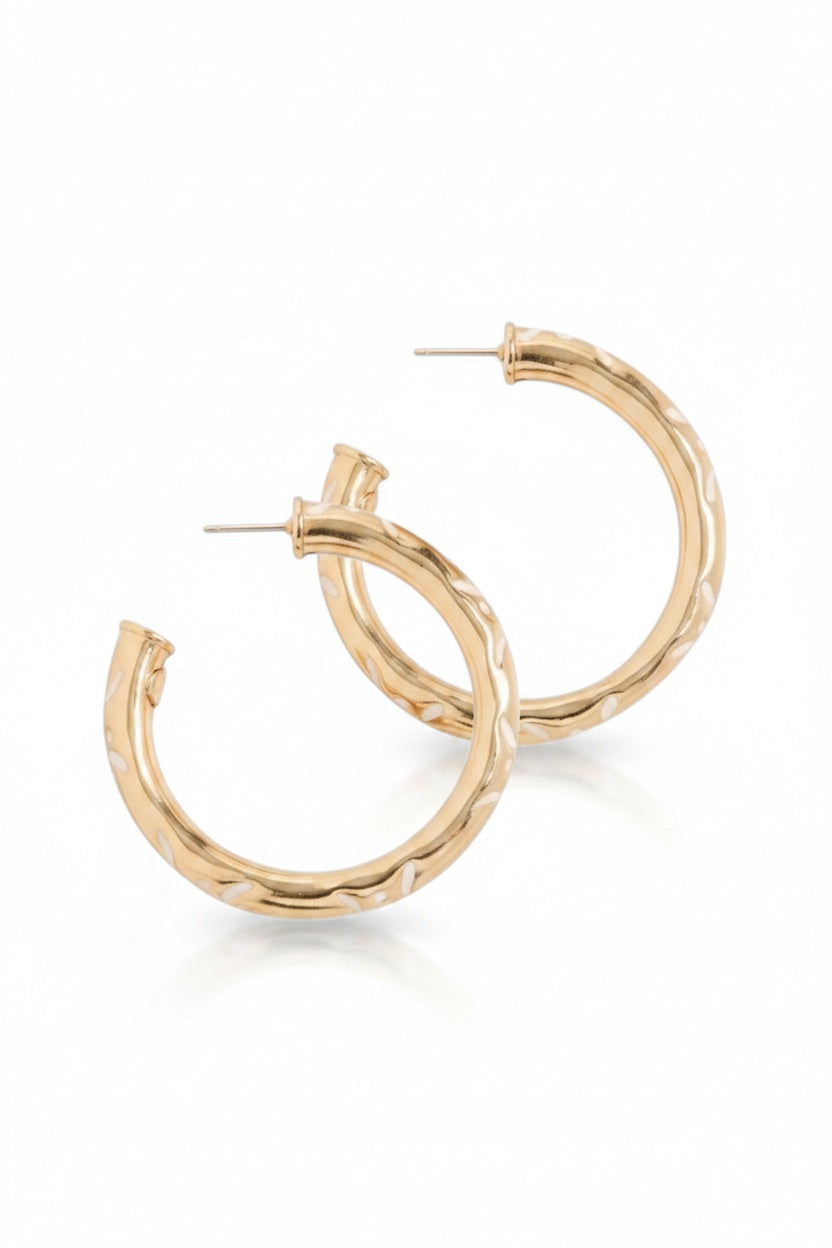 The GAS BIJOUX - BARI HOOP EARRINGS by GAS BIJOUX are 24k gold plated brass hoops featuring a subtle textured pattern, shown on a white background.