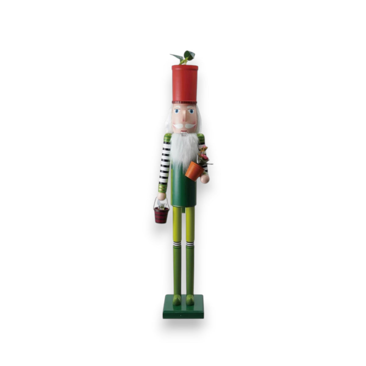 The CREATIVE COOP WOOD NUTCRACKER WITH FLOWER POT AND GARDEN TOOL wears green and yellow, holds flower pots as gardening tools, and sports a red flowerpot hat with a green sprout. Displayed on a white background.