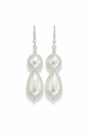 The ANN LIGHTFOOT - DOUBLE DROPLET FRESHWATER PEARL EARRINGS feature teardrop-shaped white pearls on sterling silver hooks, shown against a plain white background.