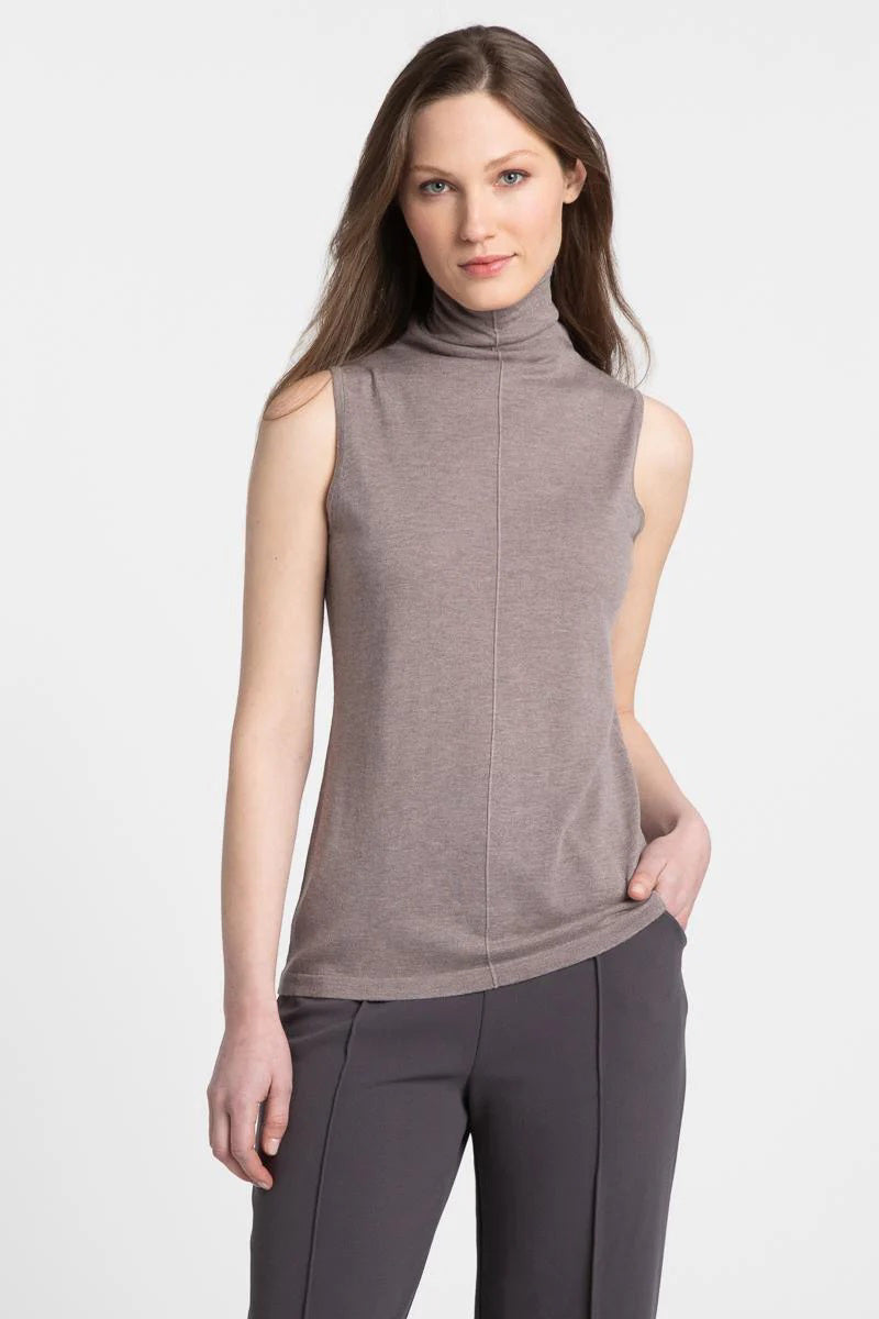 A woman smiles against a plain white background, wearing the KINROSS CASHMERE Seamed Funnel Neck Sleeveless Top by KINROSS, paired with black pants.