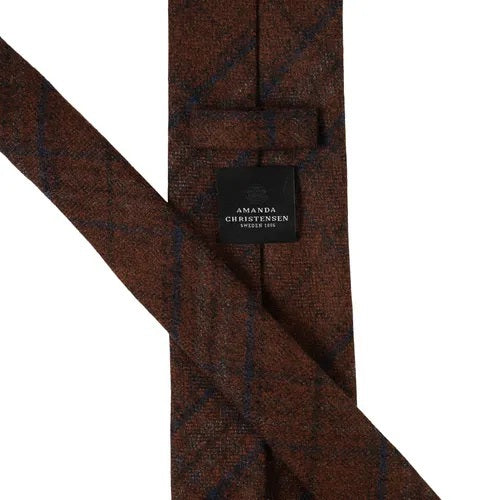A rust-colored checked wool tie from Amanda Christensen, featuring a subtle checked pattern in varying shades of rust, shown on a white background.