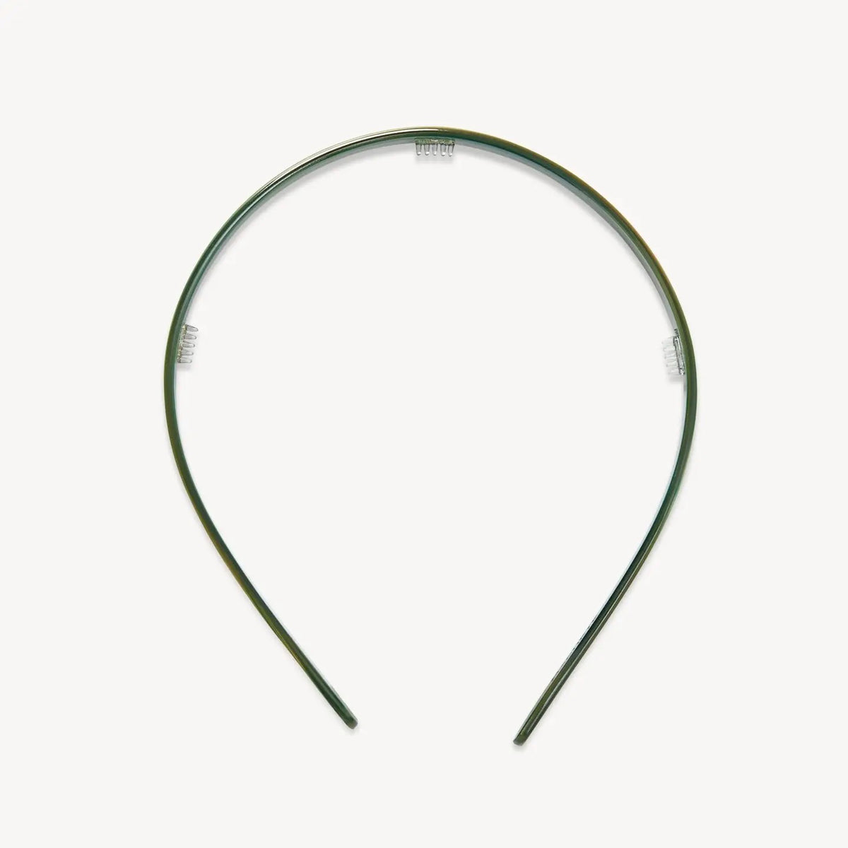 The MACHETE Ultralight Thin Headband in Meadow is a simple, slim green plastic accessory with a slight sheen, shown against a plain white background.