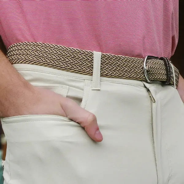 The ROOSTAS TUCSON WOVEN STRETCH BELT features khaki and brown weave, a silver buckle, brown leather accents with stitched logo at the ends for style.