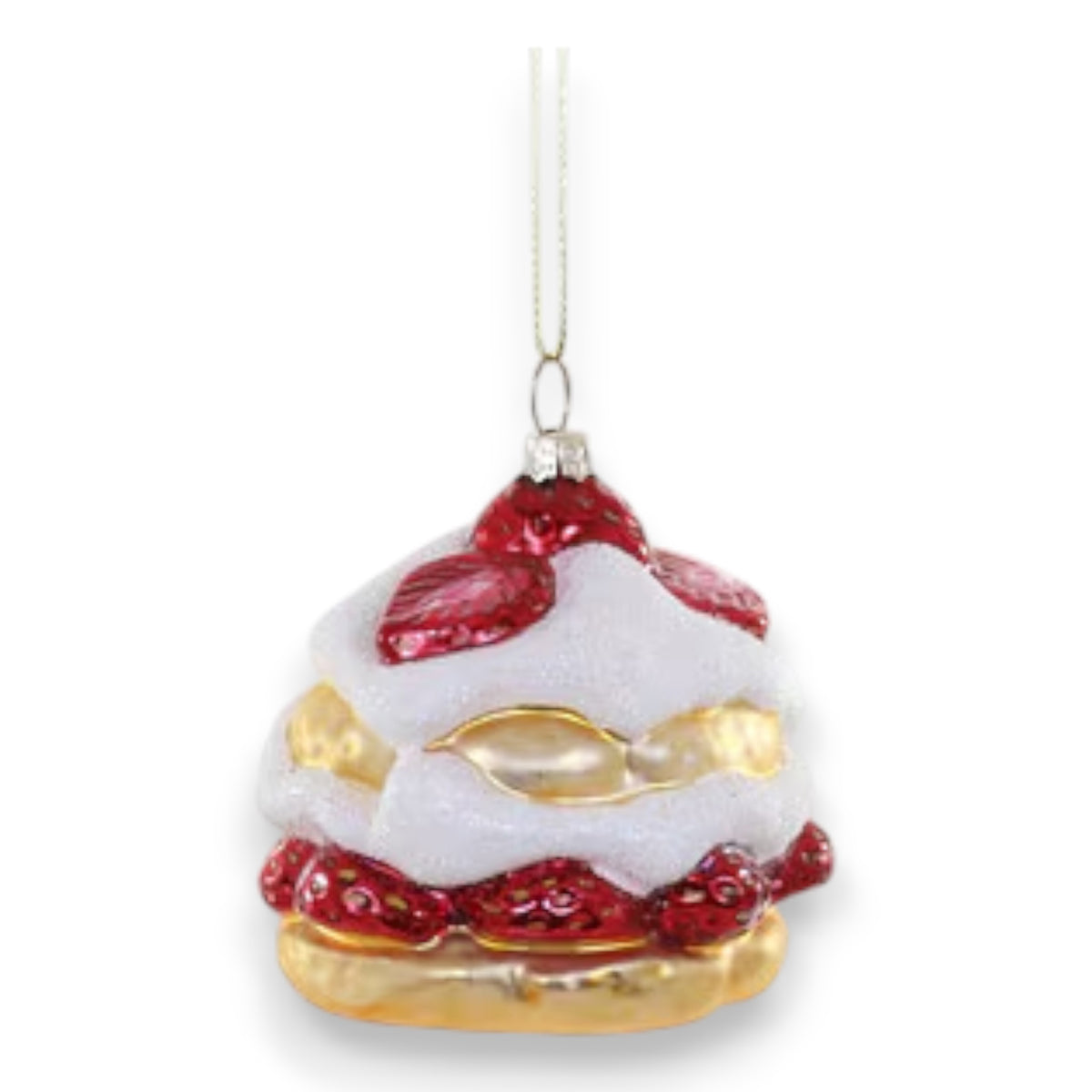 The CODY FOSTER STRAWBERRY SHORTCAKE ornament, shaped like a layered dessert with golden pastry, white icing, and red berry details on a silver string, is a charming gift for collectors or design lovers.