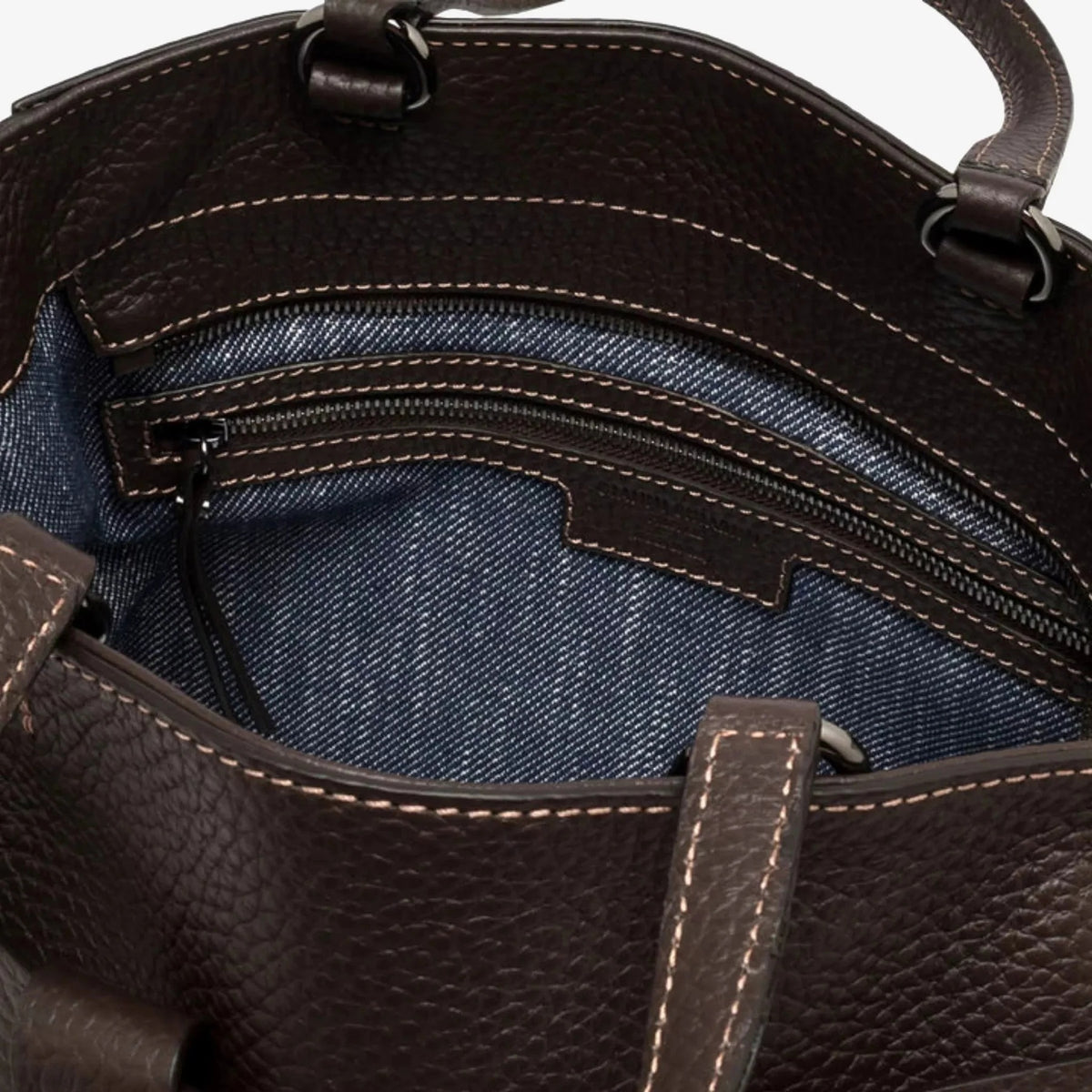 The GIANNI CHIARINI - MIRANDA HANDBAG IN ESPRESSO is a dark brown handbag crafted from pebbled, hammered leather, featuring two handles and a distinctive knotted strap detail across the front. It comes finished with a removable shoulder strap and is shown against a white background.