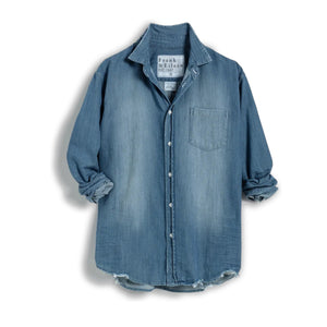 The FRANK & EILEEN LUKE Men’s Famous Denim Distressed Vintage Wash button-up features long sleeves, a front pocket, rolled cuffs, relaxed fit, visible collar label, and comes in light blue Italian denim against a white background.