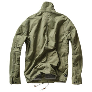 The RELWEN Pile-Lined Chore Coat in Palm Green is a stylish workwear jacket with a green quilted sleeve, olive-green collar and cuffs, and a soft gray fleece body with rugged lining, shown lying open on a white background.