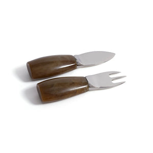The ZODAX CHEESE SET WITH RESIN HANDLES includes two elegant cheese knives—one featuring a short flat blade and the other a two-pronged fork-shaped blade—each designed with wide, brown resin handles. Presented against a white background, this stylish set makes a practical addition to any gathering or a thoughtful hostess gift.