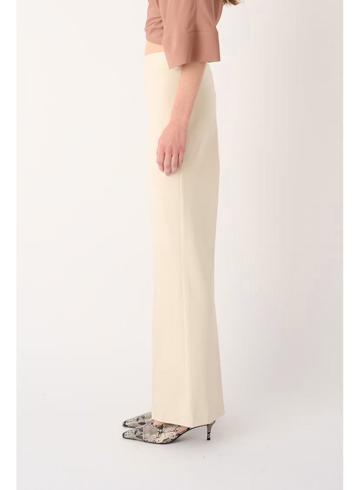 Back view of a person wearing a mauve, short-sleeved top and MEIMEIJ - PULL ON PANT IN SUGAR SWIZZLE, which are cream-colored, flared-leg trousers designed for tailored comfort.