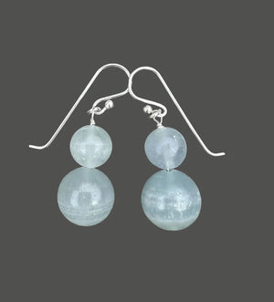 ANN LIGHTFOOT DOUBLE DROP BLUE CALCITE EARRINGS: Two round, translucent light blue calcite beads stacked vertically on each sterling silver hook, shown against a white background.