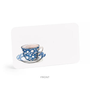 A clear plastic box contains 85 small notes, each featuring a watercolor illustration of a blue and white floral teacup on a saucer. The side label reads "E. Frances Paper - Spot of Tea Little Notes® use unsparingly.