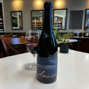 The ALMA ROSA 'Rancho La Vina' Pinot Noir 2019 from Wine: Orsini features a dark blue label, navy cap, and "alma rosa" in orange script. It showcases the Sta. Rita Hills with roasted black cherry notes from a single vineyard.