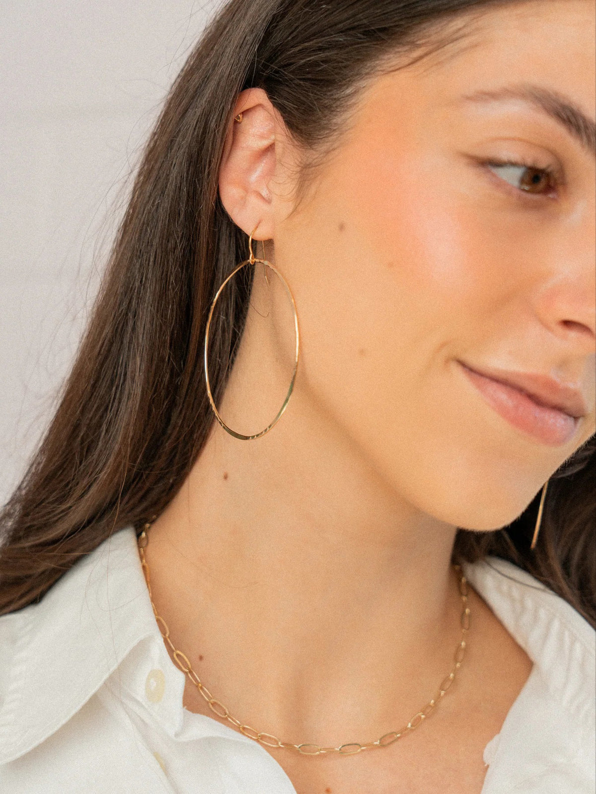 KENDA KIST - BETSY HOOPS: Large, hand-forged 14k gold filled hoops by KENDA KIST featuring simple hook clasps, shown on a plain white background.