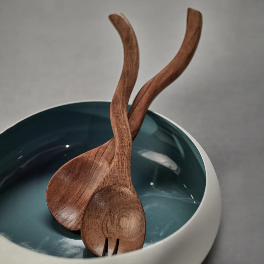 The ZODAX MANGO WOOD CURVY SALAD SERVER SET features two handcrafted servers—a spoon and fork—with a wavy design, crafted from mango wood for elegant dining. Set is displayed on a white background.