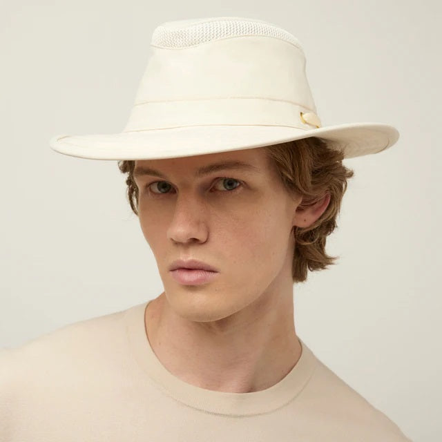The TILLEY AIRFLO BROAD BRIM HAT LTM6 in Light Stone is a recycled nylon sun hat with UPF 50+ protection, wide brim, mesh ventilation near the crown, and a small band tag. Shown on a plain white background.