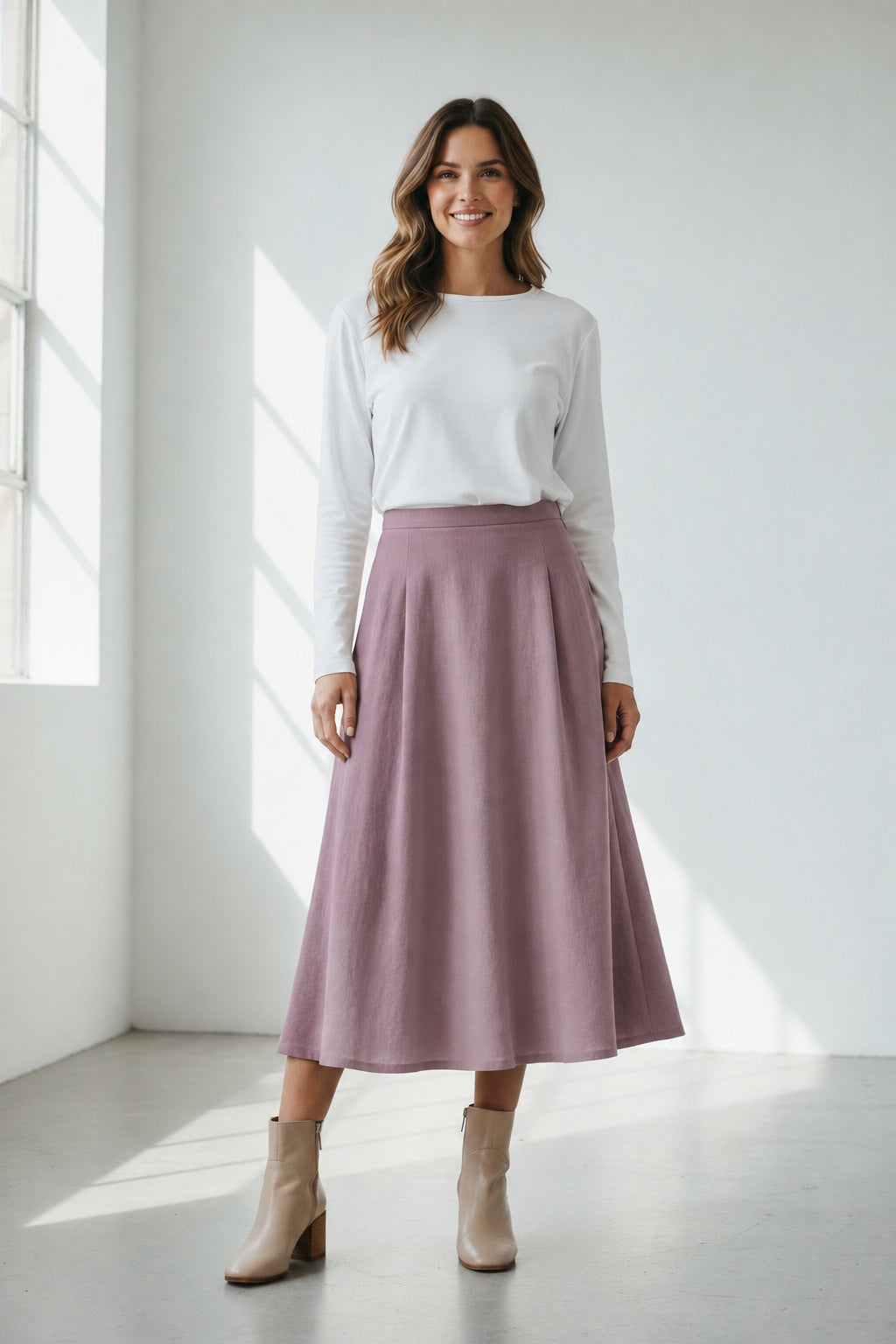 The MARNIE SKIRT by THE LITTLE PROJECT is a mustard yellow A-line design made in Los Angeles. It has a smooth texture, subtle pleats, and a side zipper, and is showcased on a plain white background.