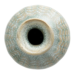 Close-up of the GRAY EMBOSSED STONEWARE VASE, SMALL by CREATIVE COOP reveals a repeating, symmetrical pattern resembling interwoven green and beige threads—much like knitted fabric or stylized leaf motifs.