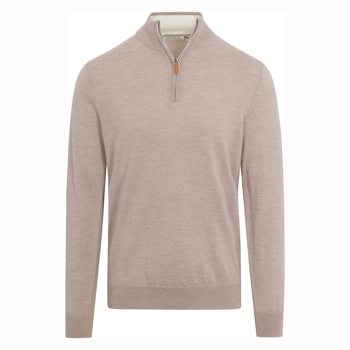 A man in glasses, wearing the COLLARS AND CO Cashmere Touch Australian Merino Wool 1/4 Zip Sweater in Oatmeal and dark jeans, walks on a cobblestone street holding a phone and a brown folder, with buildings and plants in the background.