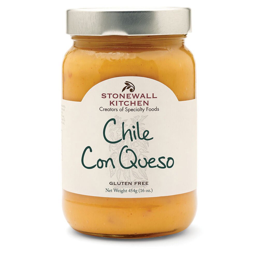 A jar of STONEWALL KITCHEN - CHILI CON QUESO, a creamy and spicy queso dip. The jar features a silver lid and a white label with green text, displaying "CHILI CON QUESO" and "Gluten Free." The net weight is 445g (16 oz).