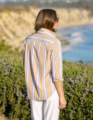 The FRANK & EILEEN EILEEN Relaxed Button Up in Italian cotton stripe features vertical yellow, blue, white, and orange stripes with long sleeves, a left chest pocket, open collar, and rolled-up sleeves for a flattering look.