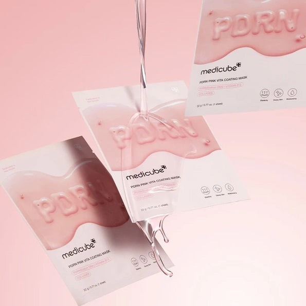 Three MEDICUBE - PDRN PINK VITA COATING MASK packets from KOSMIC KBEAUTY SKINCARE, in pink and white packaging, hang against a pastel pink background. “PDRN” is written in pink gel on each packet’s surface. This hydrating sheet mask promises glow-boosting care for visibly brighter skin.
