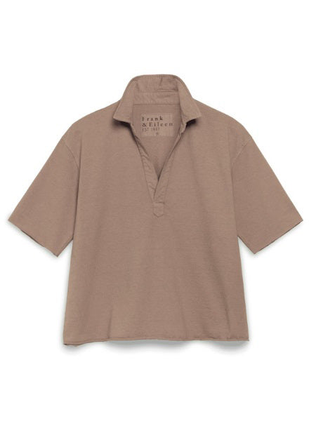 The FRANK &amp; EILEEN Patty Short Sleeve Popover in Heritage Jersey Toasted is a relaxed-fit, light brown 100% cotton shirt with short sleeves and an open V-neck, shown on a plain white background. The collar label reads &quot;Frank &amp; Eileen.