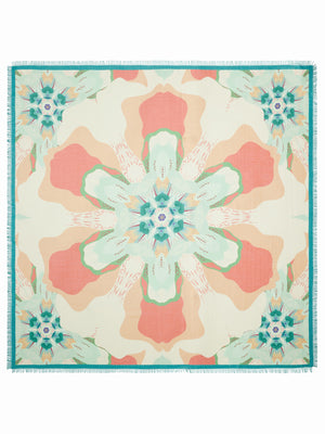 The FRANCO FERRARI Diletto Cotton Silk Scarf in Coral is designed with vibrant floral patterns and a teal border. Made from a luxurious cotton-silk blend, it features a triangular shape with fringed edges, reminiscent of Franco Ferrari scarves, and is set on a plain white background.