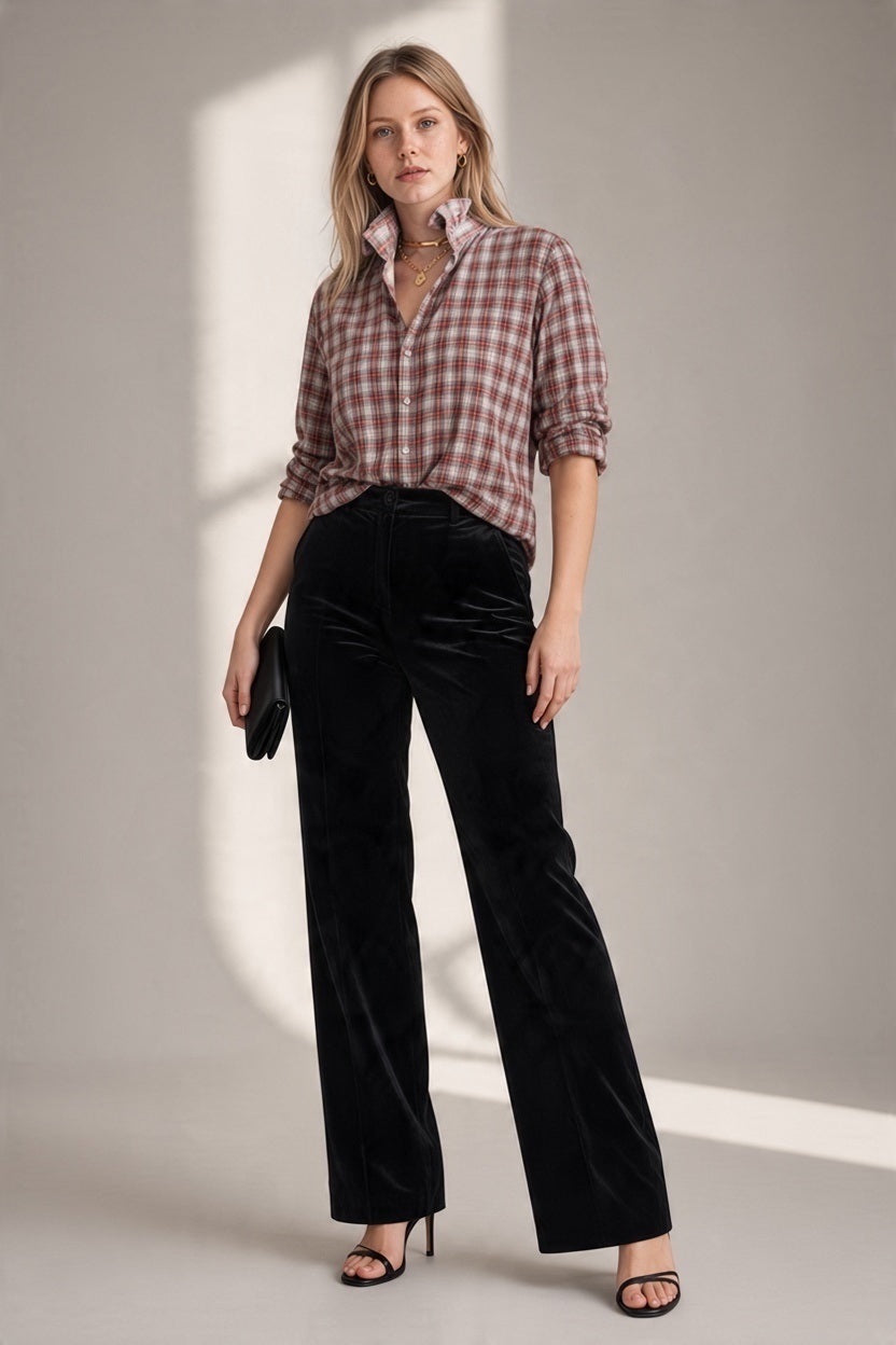 A person wears a relaxed-fit, long-sleeved red and white KMJ - QUARANTINA SHIRT IN HOLIDAY PLAID tucked into black high-waisted wide-leg trousers and black heeled sandals.