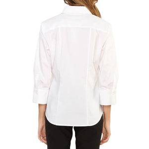 A person with long brown hair is shown from the back wearing a white HINSON WU - DIANE SHIRT with a collar and sleeves ending just below the elbows, paired with black pants.