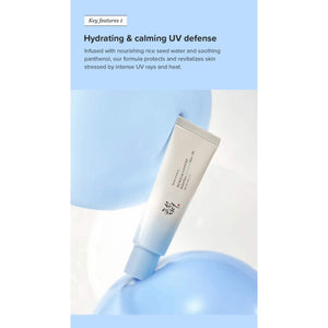 A tube of KOSMIC KBEAUTY SKINCARE BEAUTY OF JOSEON - RELIEF SUN SUNSCREEN, AQUA FRESH SPF 50+ is positioned on and next to four ice cubes containing embedded flowers, set against a crisp white background.