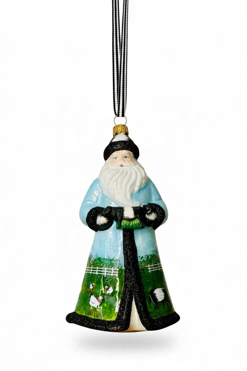 The JOY TO THE WORLD COLLECTIBLES FEARRINGTON SIGNATURE COLLECTION Handmade Santa Ornament features a bearded man in a blue and black robe with farm animals, a black hat and gloves, and a striped hanging ribbon.