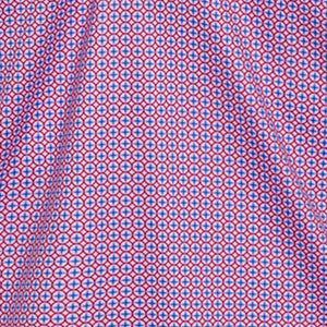 The COLLARS AND CO SEMI SPREAD COLLAR POLO IN CRIMSON COMPASS features a geometric pattern of blue circles and red crosses on white fabric, offering comfort and 4-way stretch for a vibrant, textured look.
