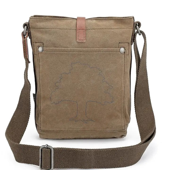 The TSD BRAND - FOREST ZIP CROSSBODY BAG IN OLIVE is a military-inspired khaki canvas bag with a front pocket, brown adjustable strap, decorative leather buckle, metal rivets, and textured shoulder strap for style and durability.
