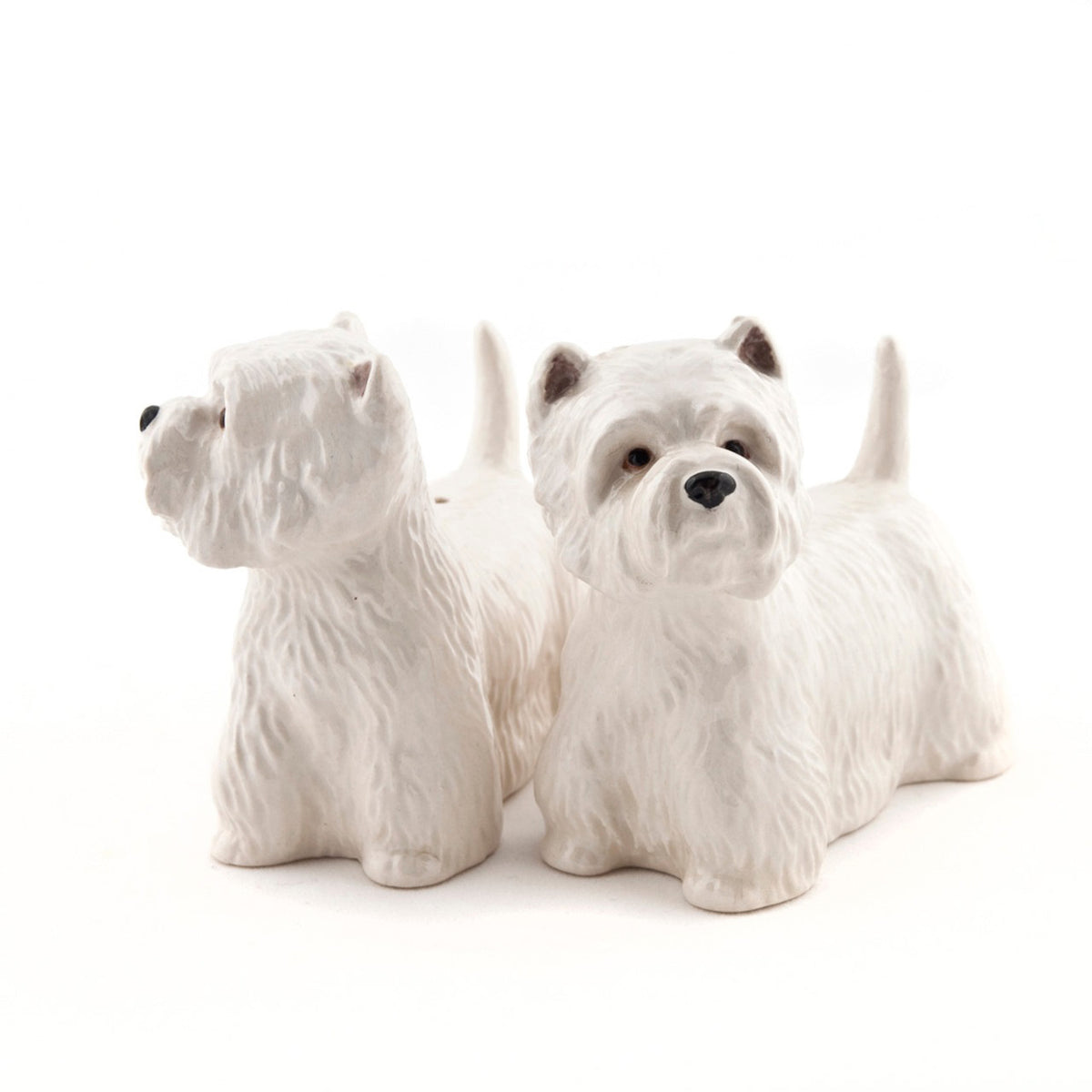 The QUAIL CERAMICS - WESTIE SALT AND PEPPER SET by QUAIL DESIGNS features handpainted stoneware shakers shaped like white West Highland Terriers. Charming and dishwasher safe, they’re displayed side by side on a white background.