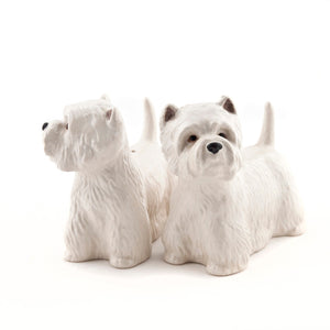 The QUAIL CERAMICS - WESTIE SALT AND PEPPER SET by QUAIL DESIGNS features handpainted stoneware shakers shaped like white West Highland Terriers. Charming and dishwasher safe, they’re displayed side by side on a white background.