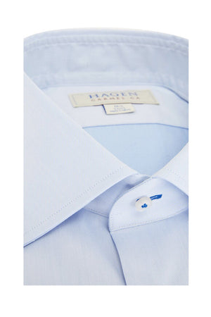 The HAGEN - COTTON DRESS SHIRT IN LIGHT BLUE is neatly folded, featuring a modern spread collar, white buttons, and premium cotton. The label inside the collar displays "Hagen Carmel, CA" with size details.