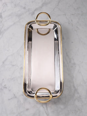 The ZODAX POLISHED NICKEL AND GOLD TRAY showcases a rectangular silhouette in polished nickel, elegantly accented with gold trim and two large gold handles at each end, displayed from an overhead view against a white background.