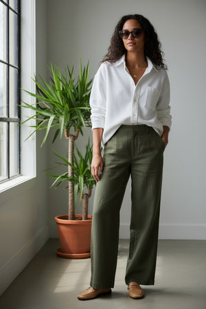 The FRANK & EILEEN Eileen Relaxed Button Up in Triple Fleece White features long sleeves, a single chest pocket, rolled cuffs, and a curved hem, shown against a white background.
